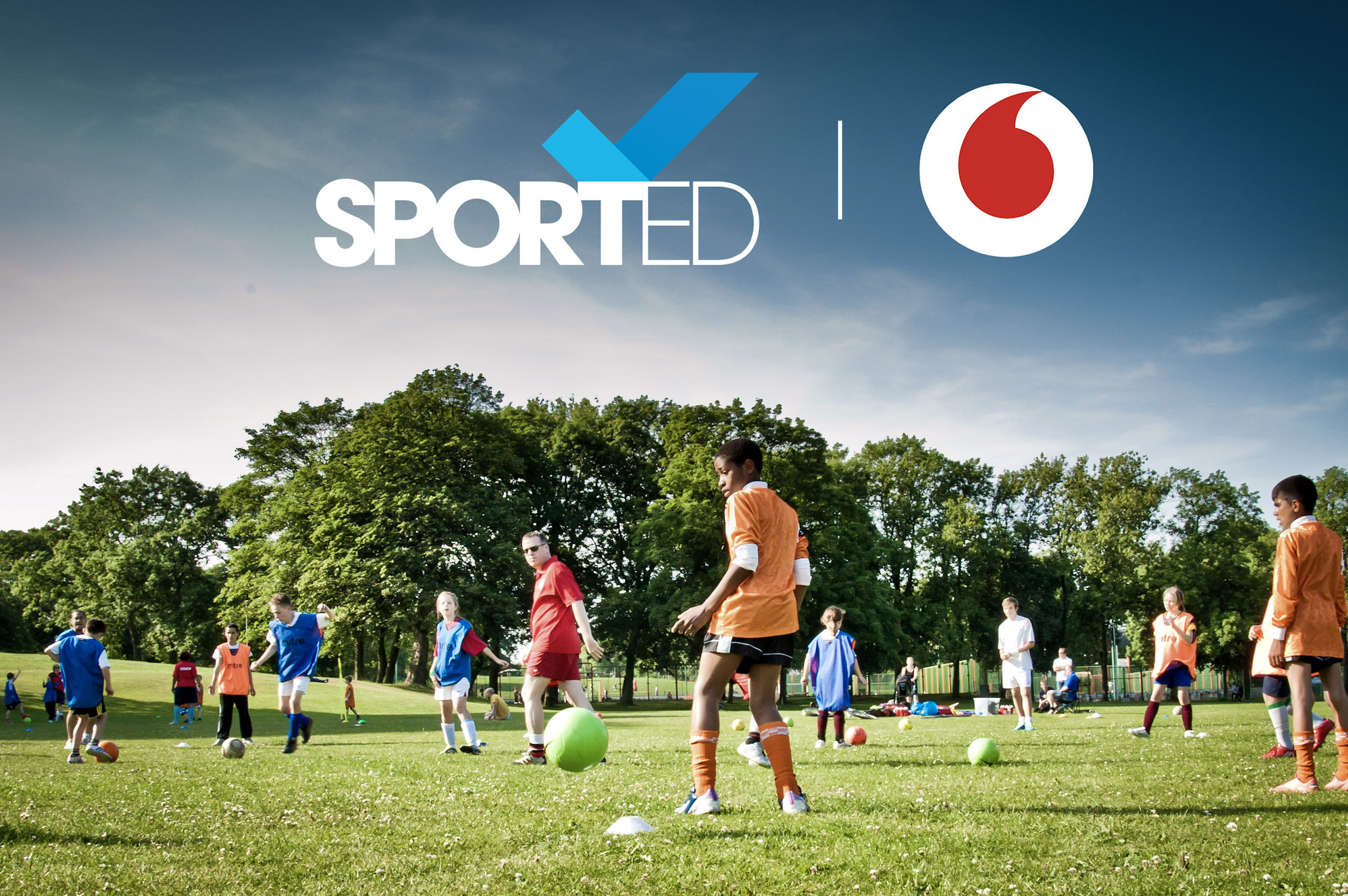 photo of a grassroots community football match with the Sported and Vodafone logos superimposed over the sky