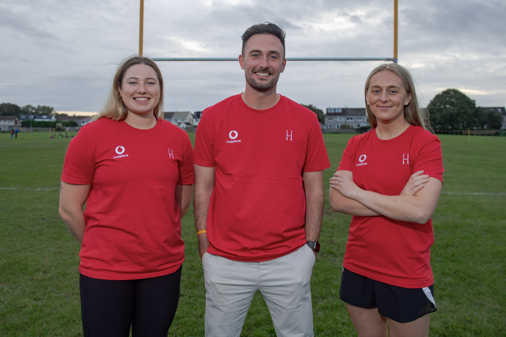 photo showing Gwen Crabb, Rob Shotton and Captain Hannah Jones on a rugby pitch.