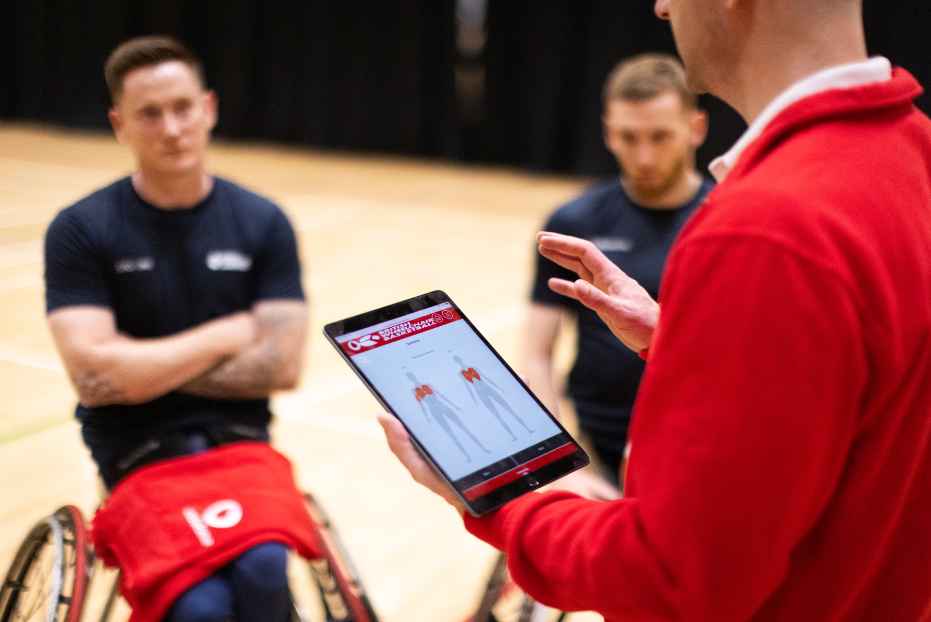 Vodafone PLAYER.Connect Performance Consultant, John Mulcahy, sharing performance data with British Wheelchair Basketball Men's team players.