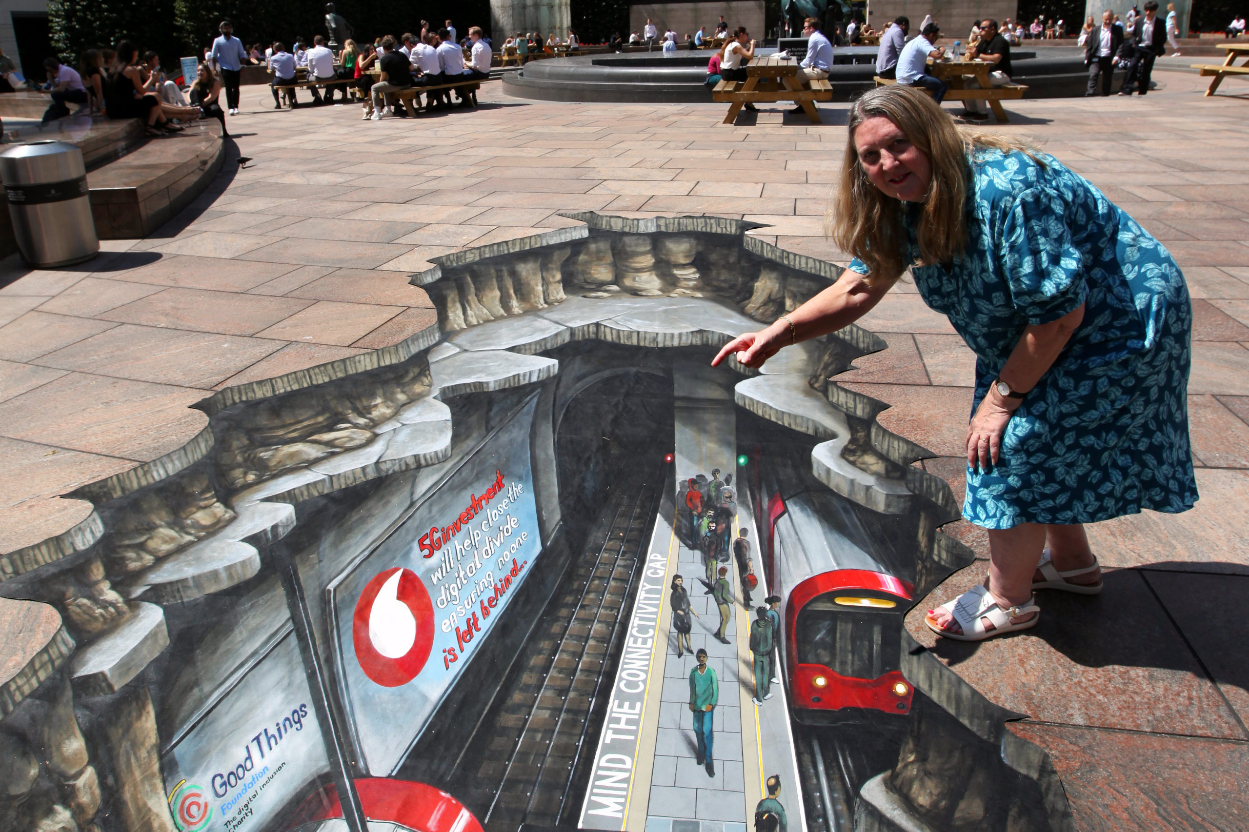 Helen Milner, CEO of Good Things Foundation, with Vodafone's 'mind the gap' street art.