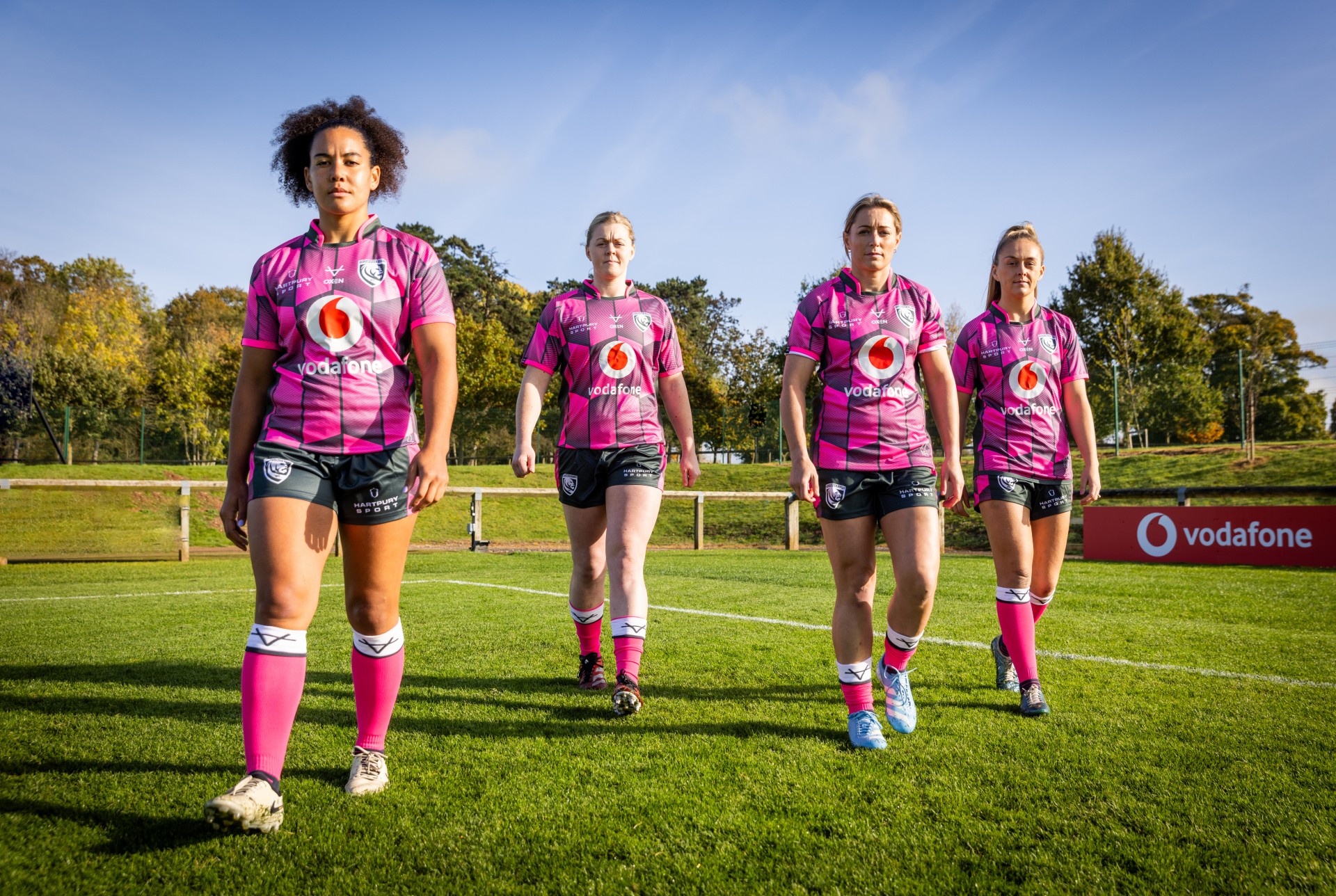 Players of Premiership Women's Rugby champions, Gloucester Hartpury Rugby, posing in new Vodafone-sponsored kit.